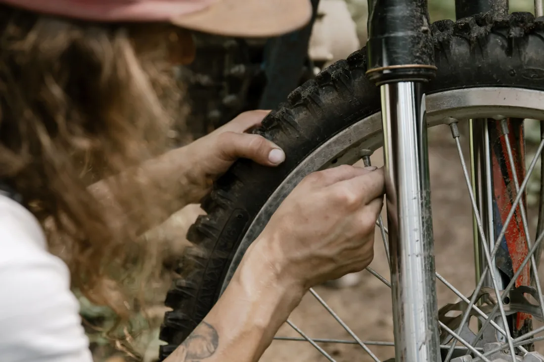 Rider working on an off-road motorbike