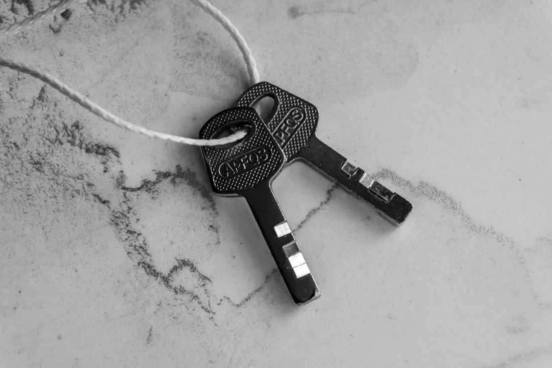 Set of door keys on a dark surface