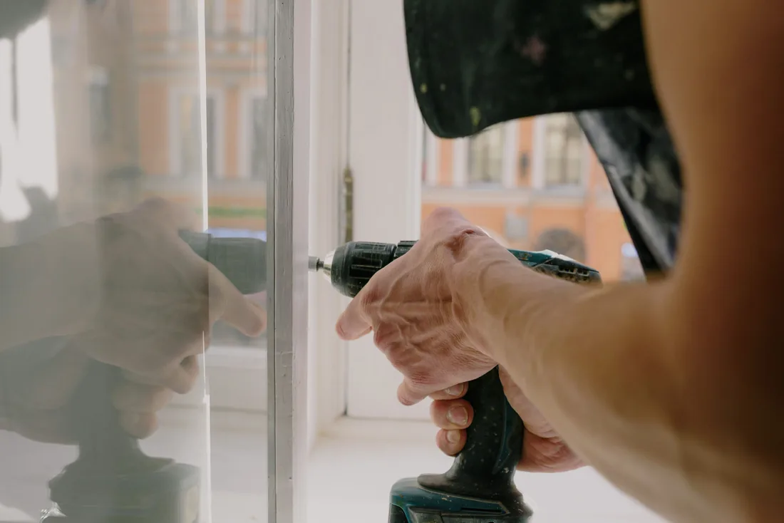 Installer fitting hinge hardware to a door frame