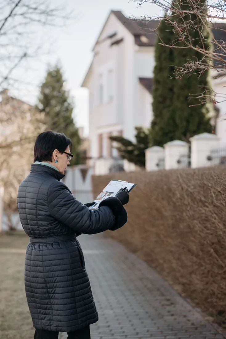 Specialist inspecting the exterior of a home during a security audit