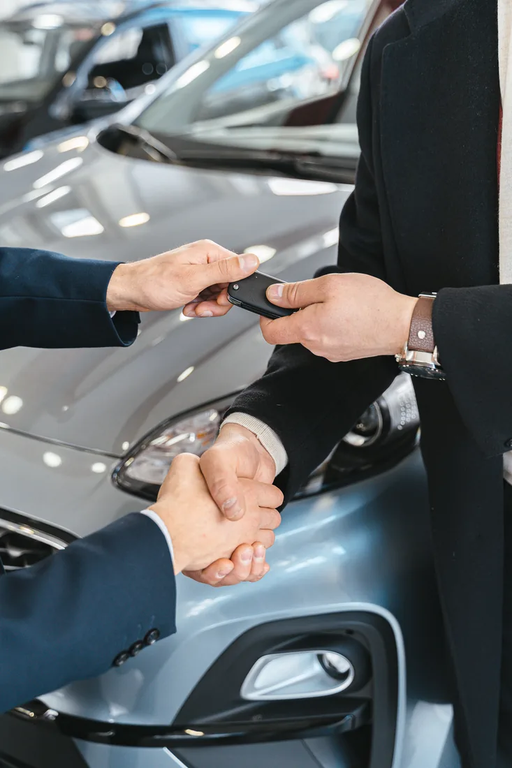 Car key fob being handed over to a customer