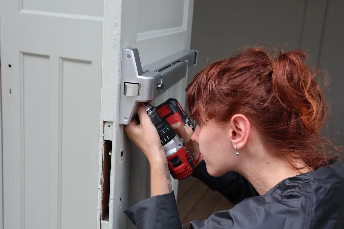 Locksmith rekeying a residential door lock