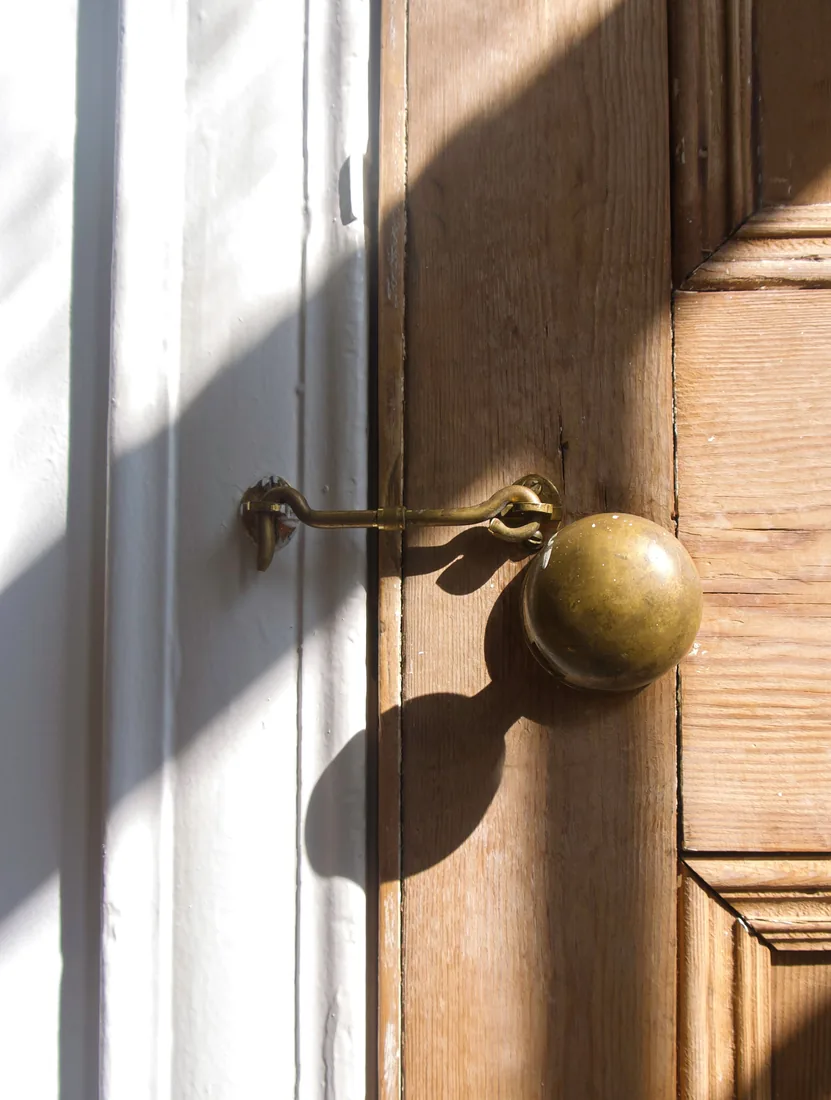 Brass mortise handle on a solid wooden door